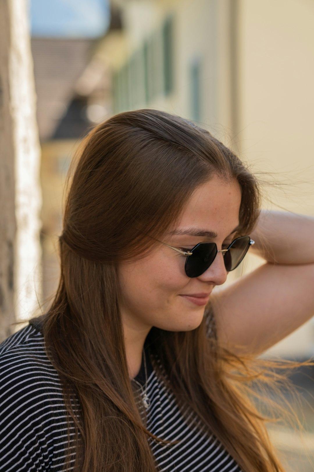A woman in a black and white shirt and sunglasses